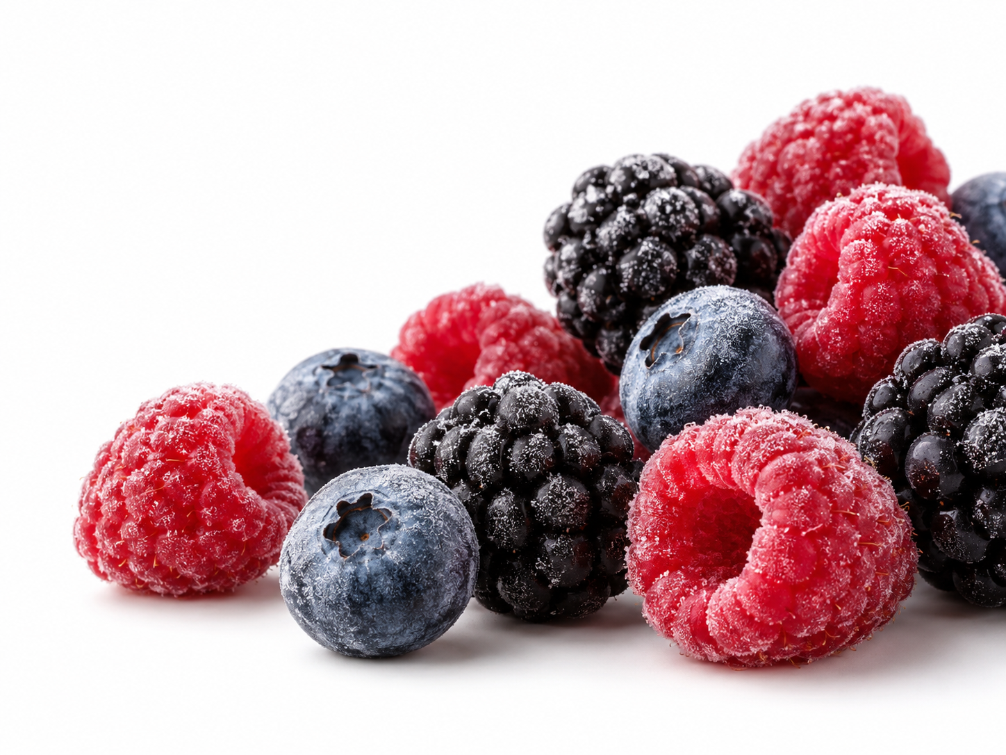 Raspberries, blueberries and blackberries with fine frost crystals